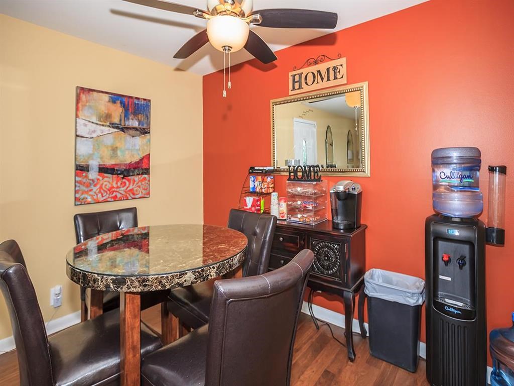 a dining room with a table and chairs
