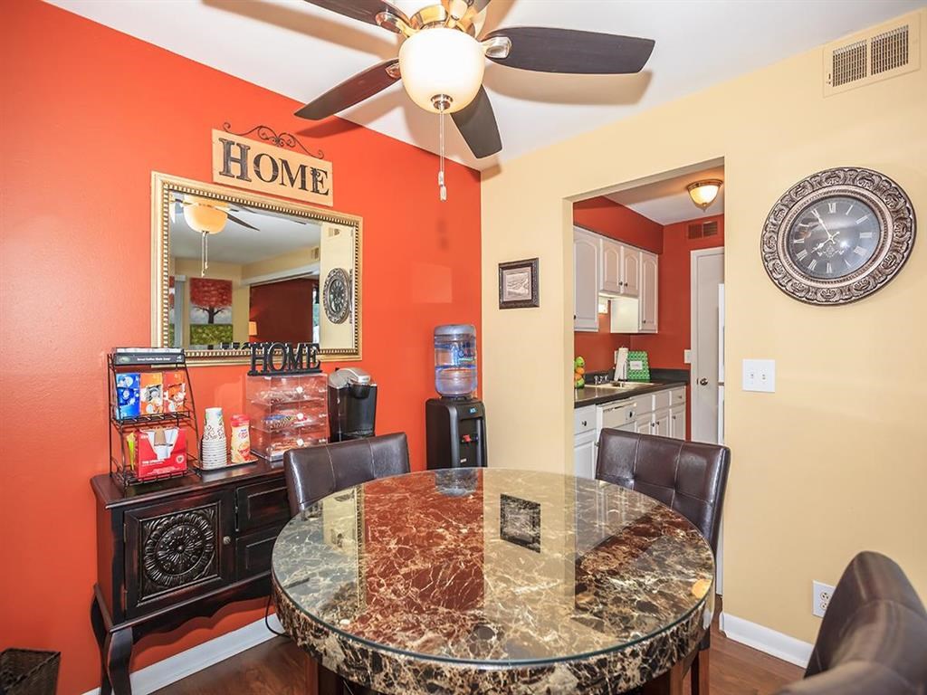 a dining room with a table and a ceiling fan