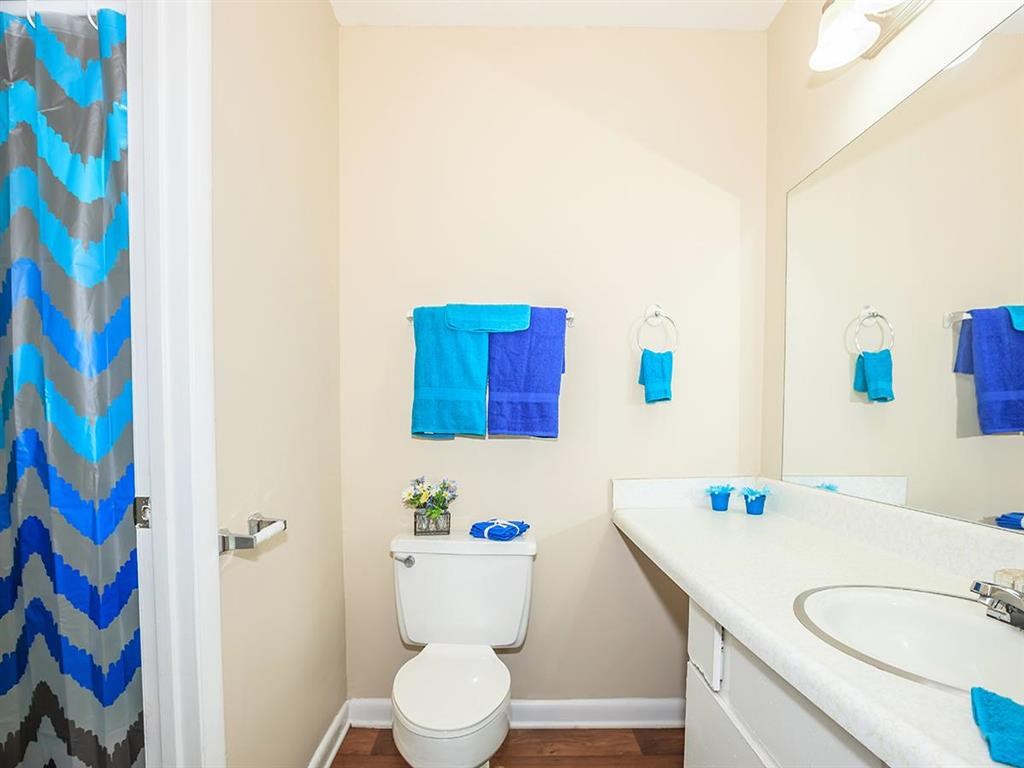 a bathroom with a sink toilet and a mirror