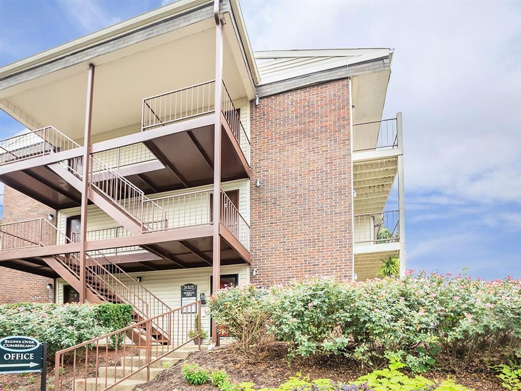 the exterior of an apartment building with stairs