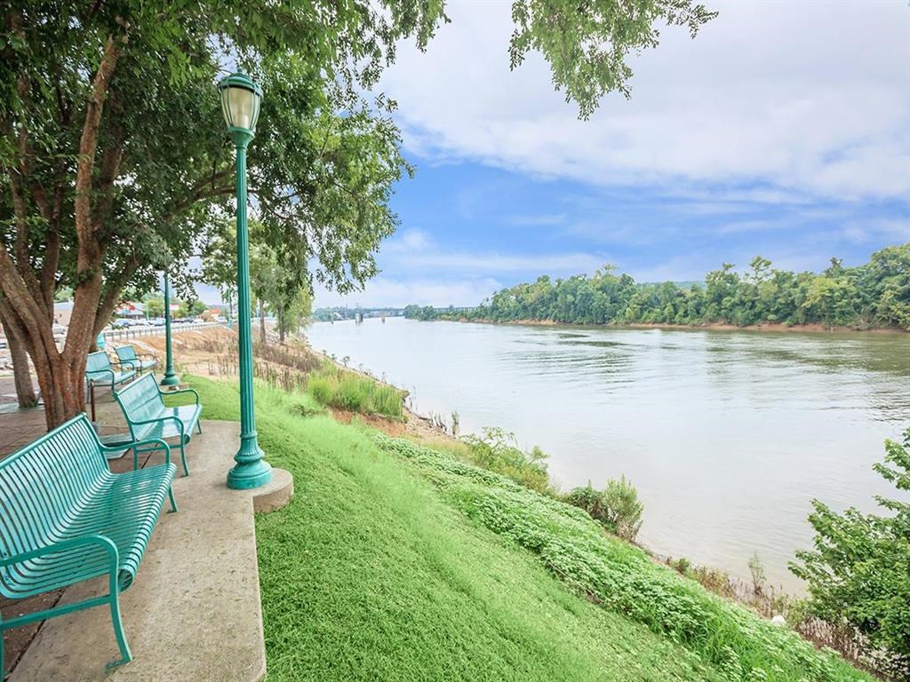 a row of benches sitting next to a river