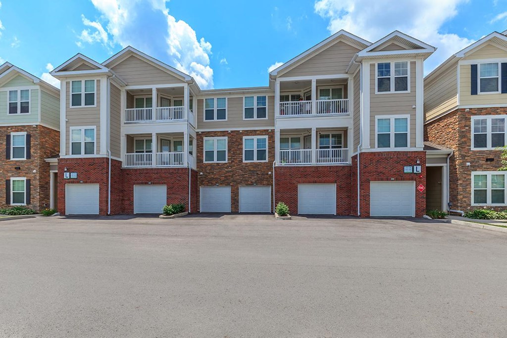 an empty parking lot in front of an apartment building