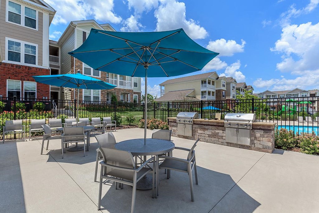 our patio has tables and chairs and umbrellas and a pool