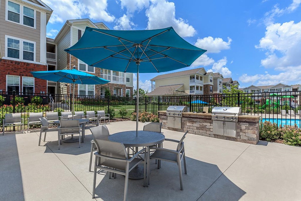 our patio has tables and chairs and umbrellas and a pool