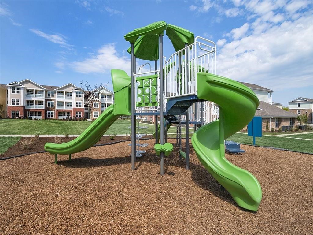 a playground with a slide in a park