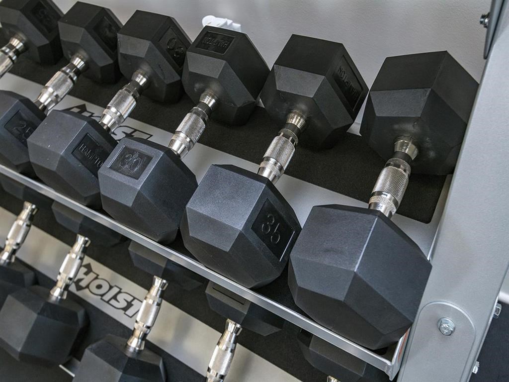 a row of weights on a rack in a gym