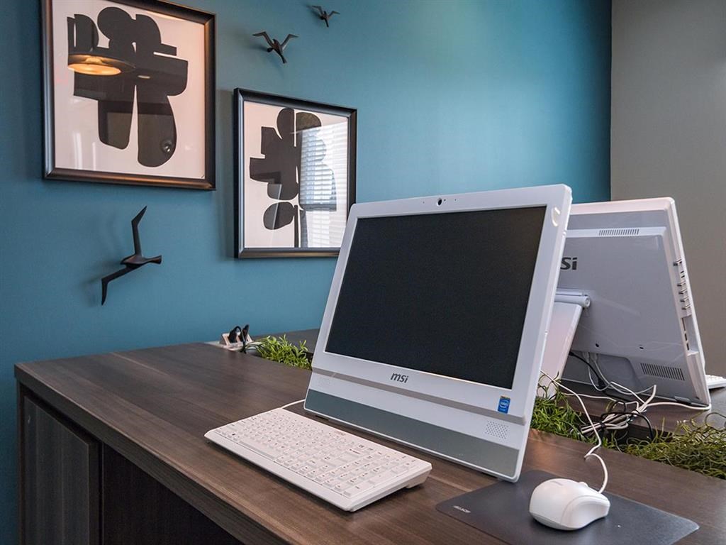 a desktop computer sitting on top of a wooden desk