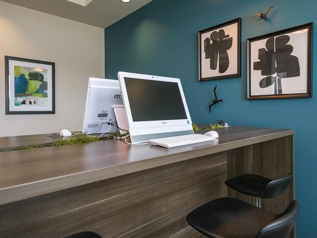 a desk with a computer on top of it