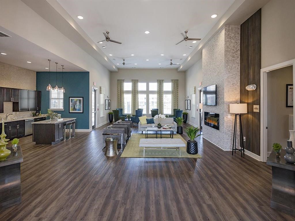 a large living room with furniture and a fireplace