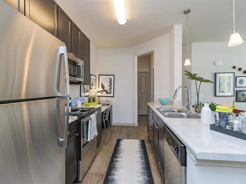 a kitchen with stainless steel appliances and a sink