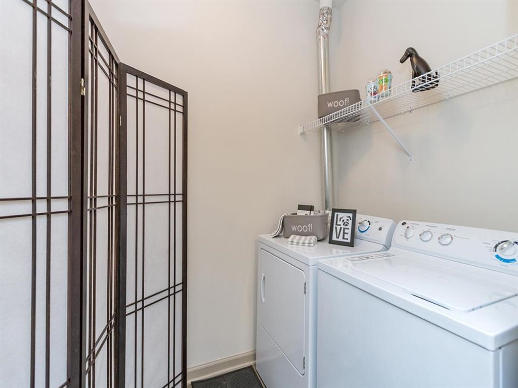a washer and dryer in a laundry room with a closet