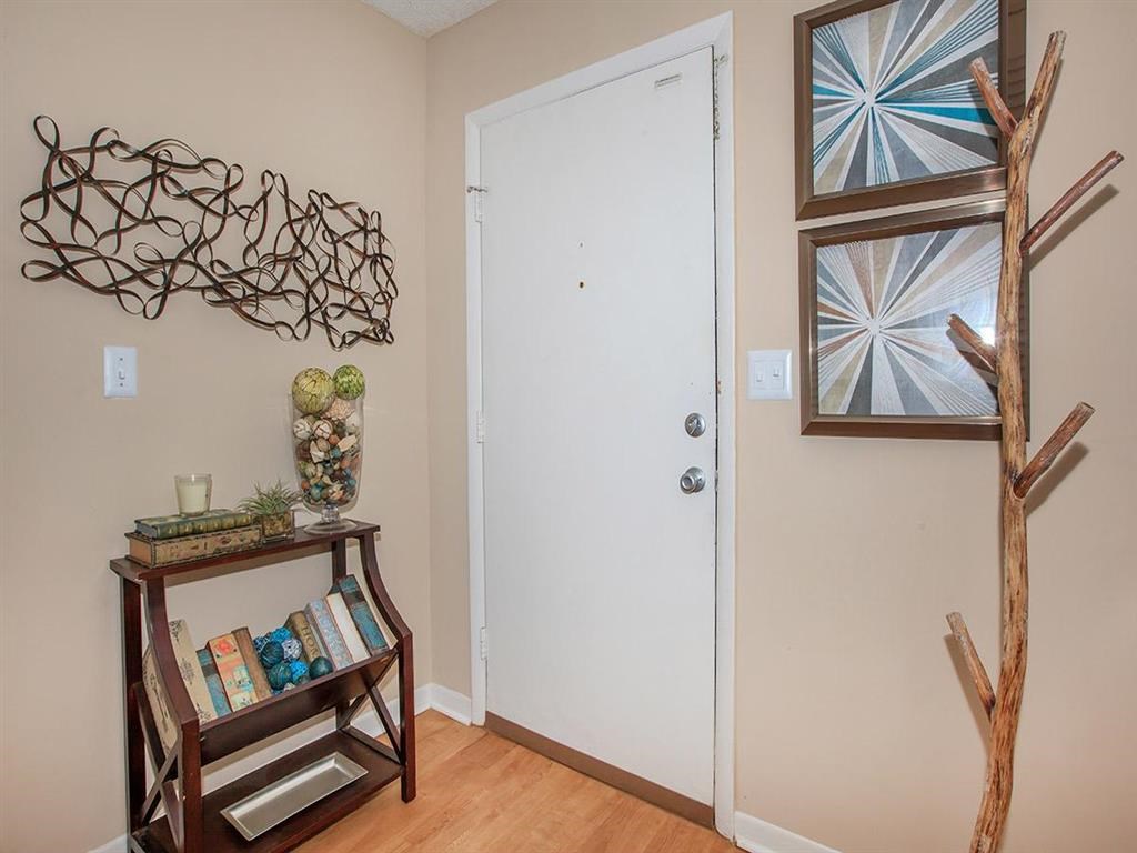 a living room with a white door and a shelf