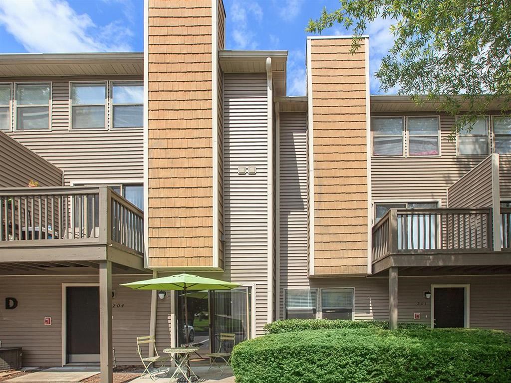 a patio with an umbrella in front of a building
