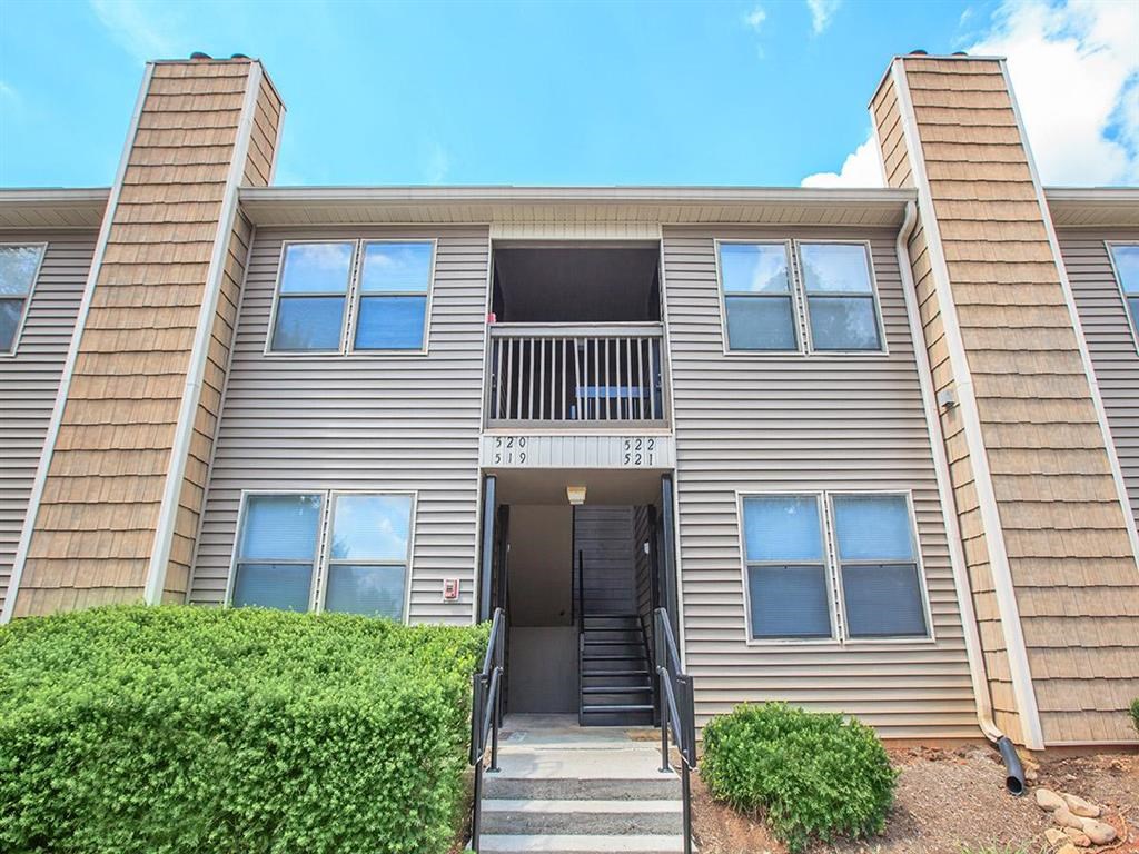 an apartment building with stairs and a front entrance