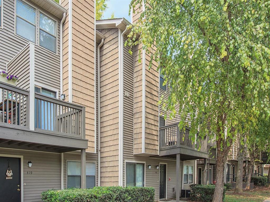 an apartment building with balconies and trees