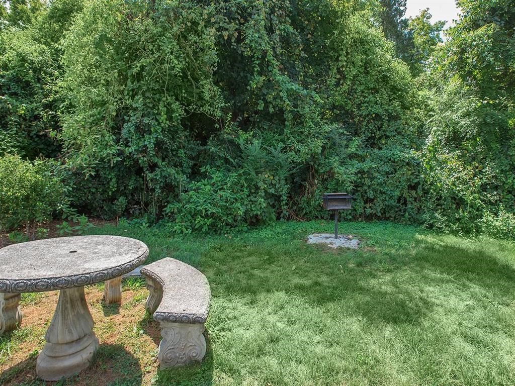 a backyard with a picnic table and a fire pit
