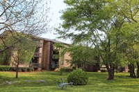 a house with a plane in the grass in front of it