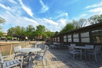 a view of the patio with tables and chairs