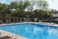 a swimming pool with chairs around it at a hotel