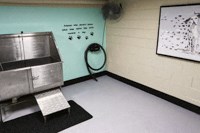 a room with a stove and a monitor on the wall