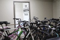 a bunch of bikes parked in front of a door