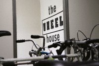 a bunch of bikes parked in front of a wall