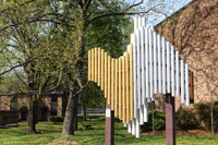a large white and yellow sculpture in a park
