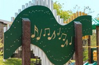 a green sign in the shape of an alligator