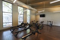 a fitness room with exercise bikes in it