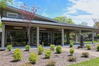 a view of the front of a building with a lawn and plants