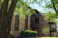 a brick building with a tree in front of it
