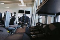 a gym with a bunch of exercise equipment in it