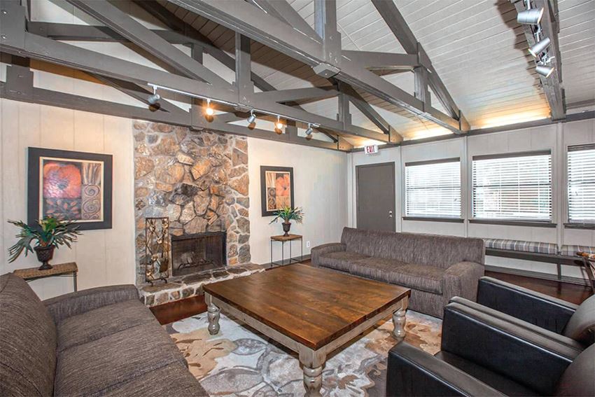 a living room with couches and a table and a fireplace