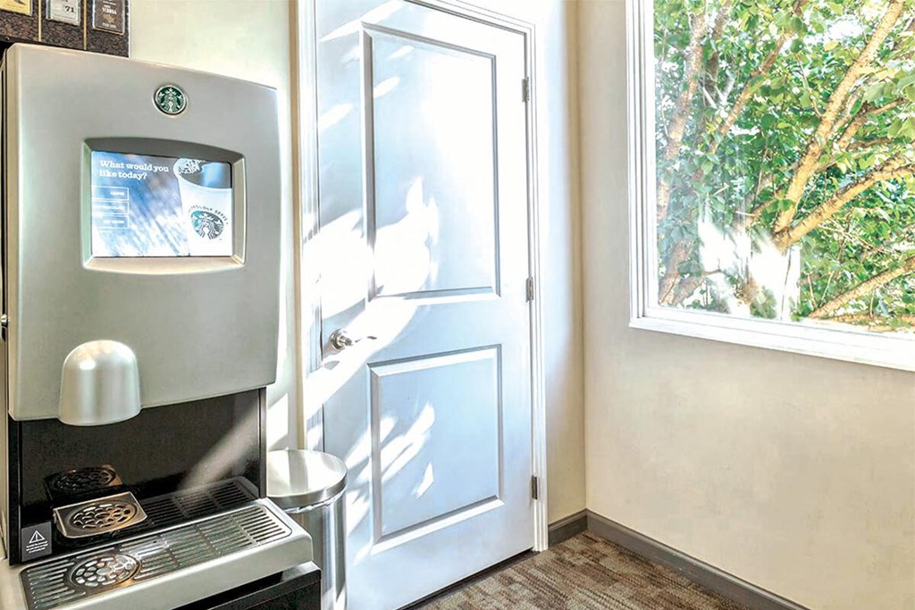 a kitchen with a door and a stove and a window