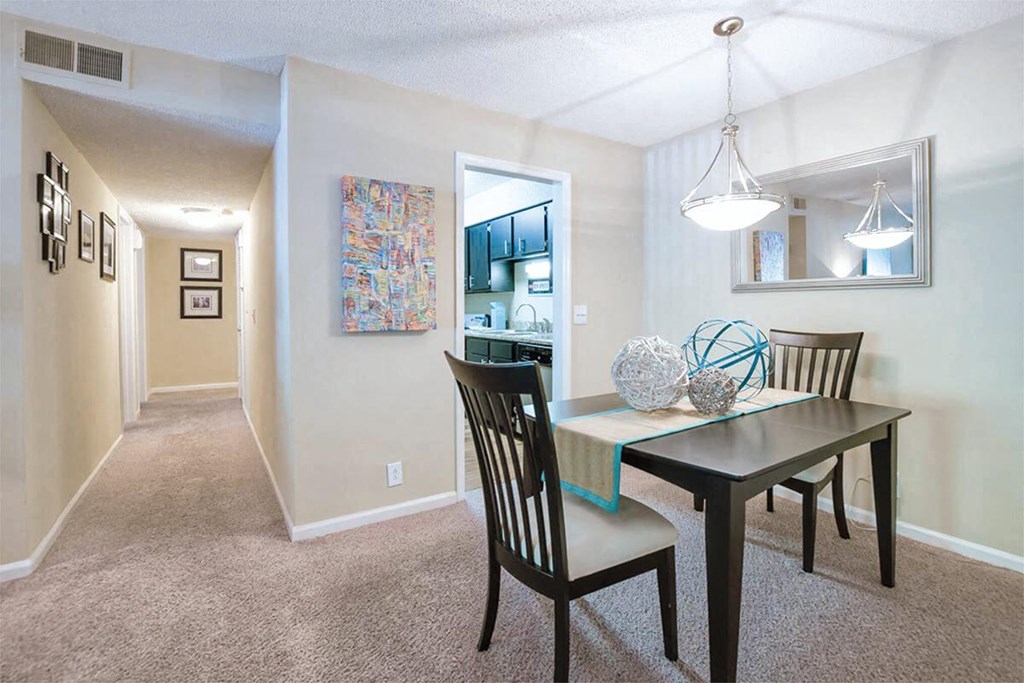 a dining room with a table and chairs
