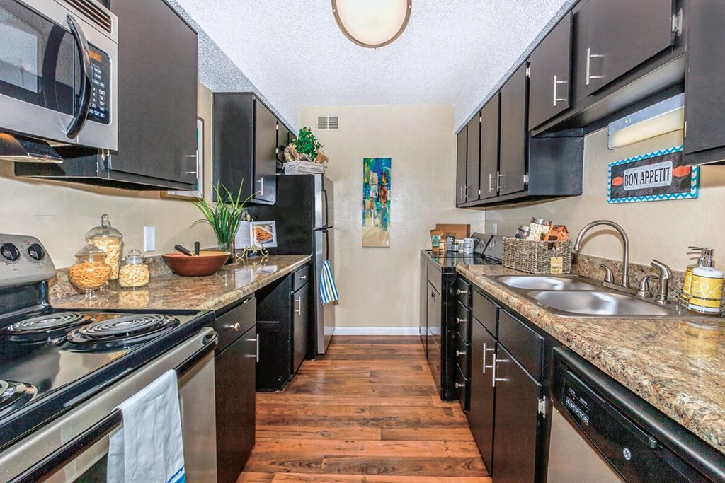 a kitchen with stainless steel appliances and granite counter tops