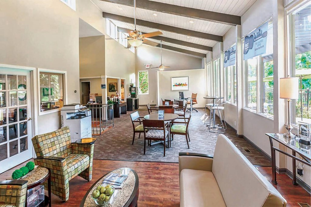 a large living room with a dining room table and chairs