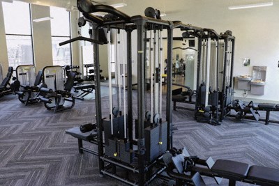 a gym full of exercise equipment in a building