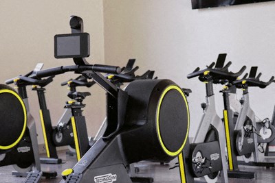 a row of exercise bikes in a gym