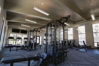 a fitness room with weights and other exercise equipment