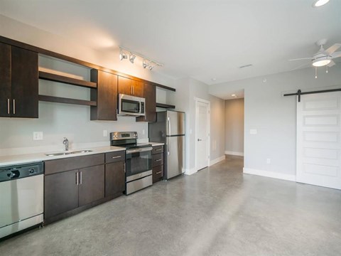 an empty kitchen with stainless steel appliances and