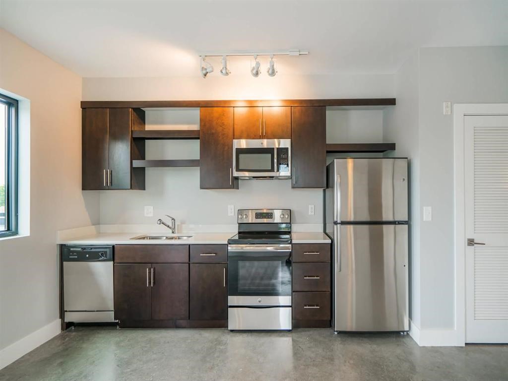 a kitchen with stainless steel appliances and wooden cabinets