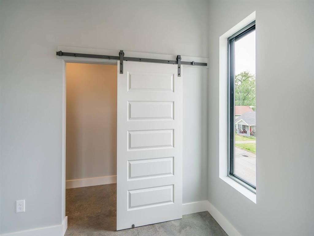 a white sliding door in a room next to a window