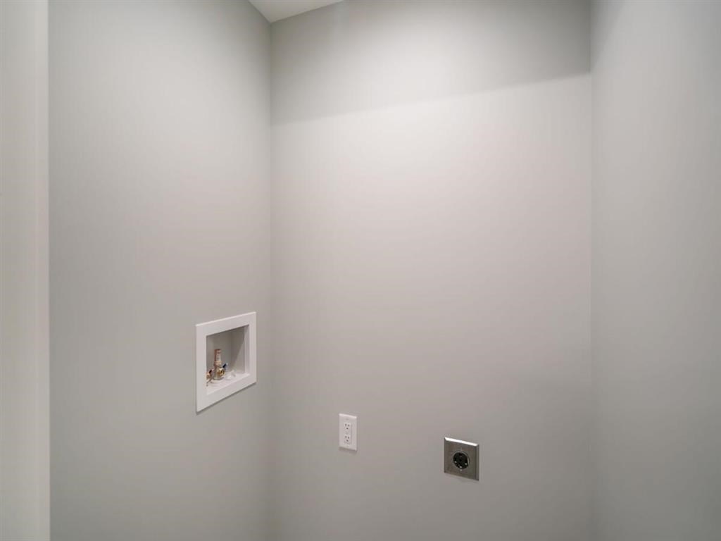 a white wall with a hole in it and two electrical outlets
