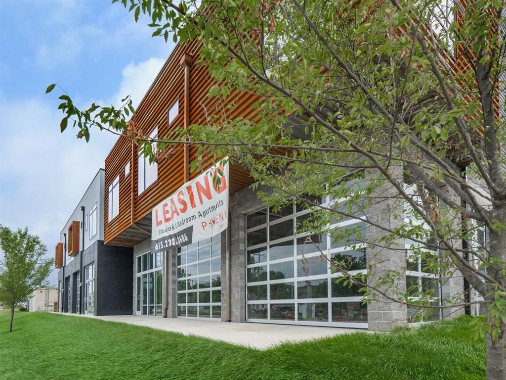 a building with a leasing sign in front of it