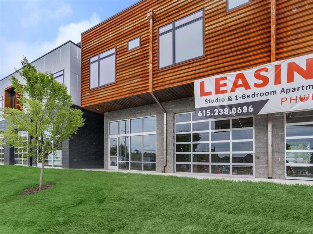 a building with a leasing sign on the side of it