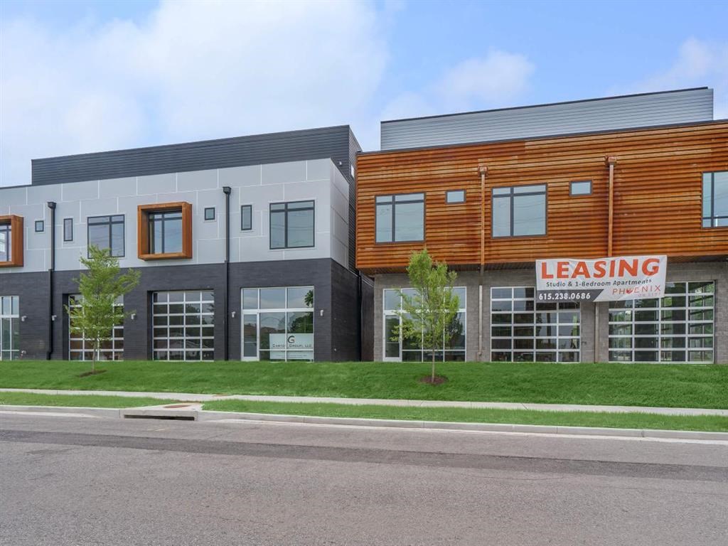 a rendering of a building with a leasing sign in front of it
