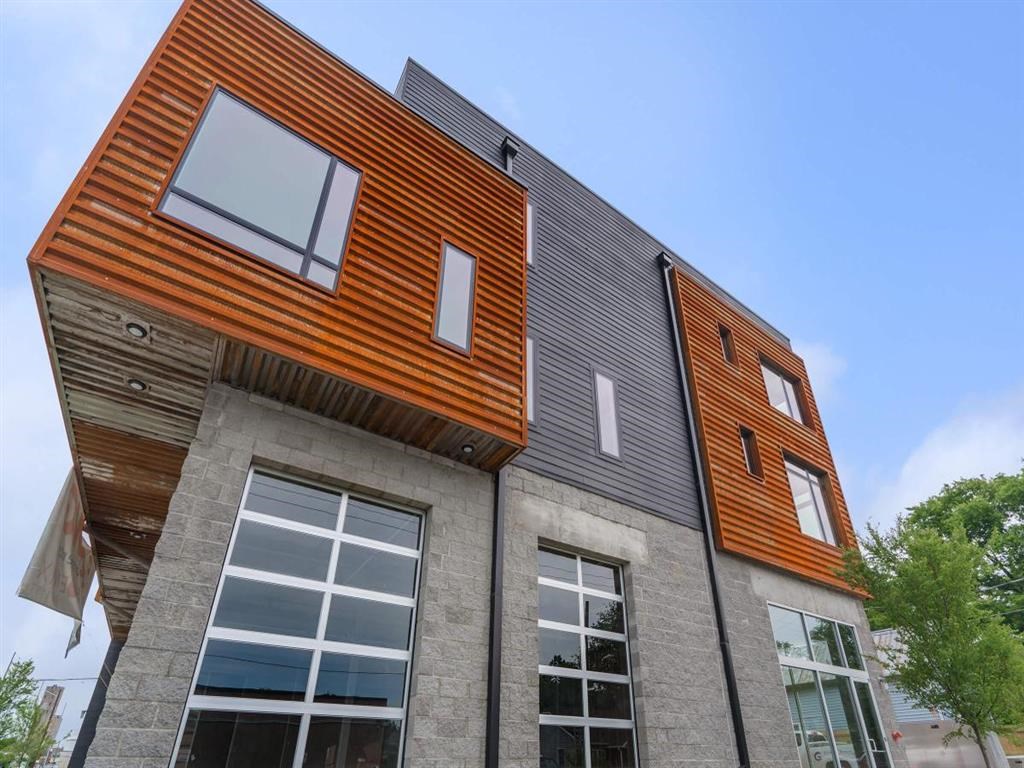 the house has a lot of windows and a slanted roof