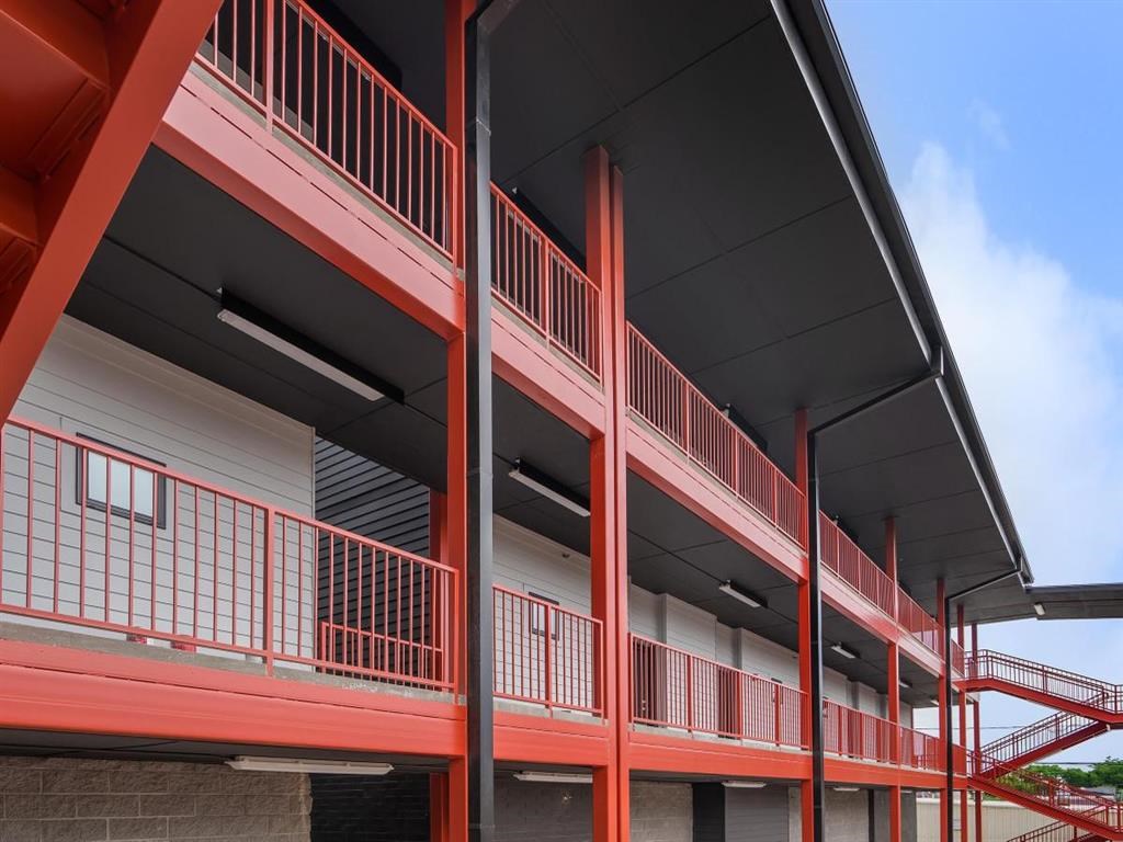 a view of a building with red balconies