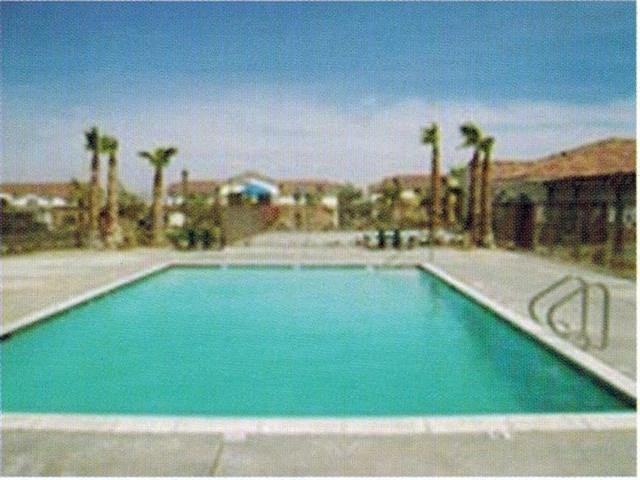 Pool with Lounge Chairs l Casa Bella Apartments in Victorville CA
